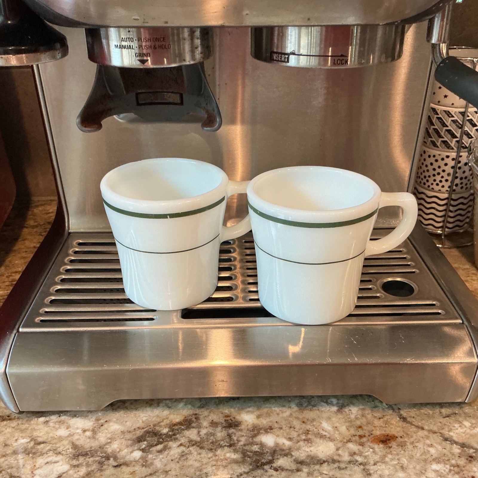 Vintage Pyrex Restaurant Ware milk glass mugs featuring dark green stripe bands