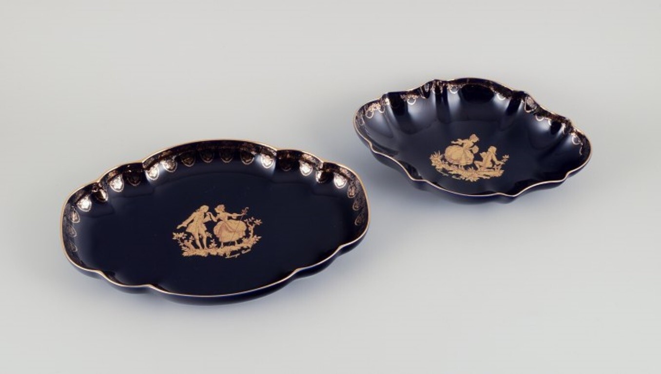 Limoges, France. Two porcelain serving platters adorned with 22-karat gold leaf
