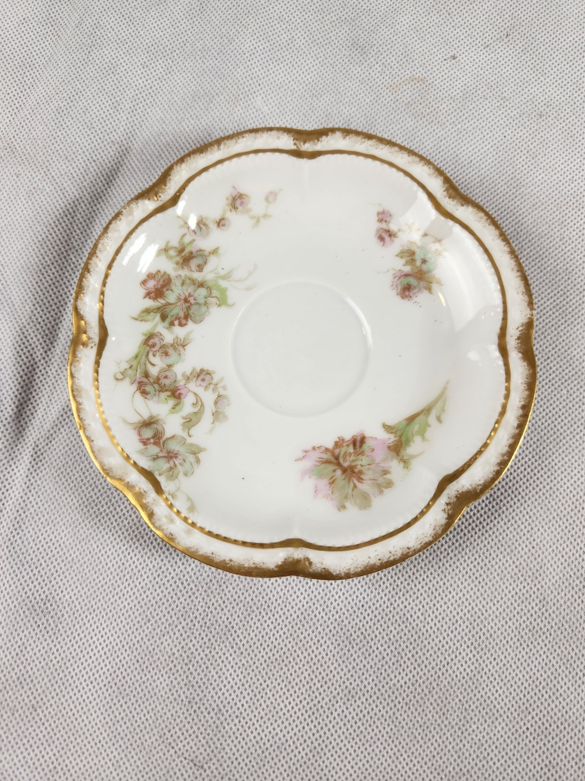 This is a Vintage Haviland Limoges saucer in a pink and green floral pattern.