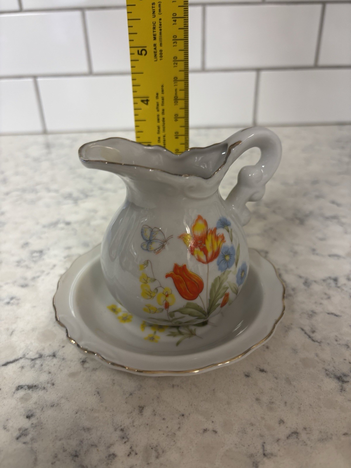 VTG porcelain creamer and saucer set with floral and butterfly. Made In Japan.