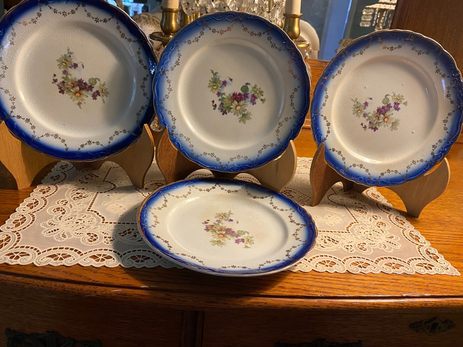 SET OF FOUR OLDER 7/1/2″ PLATES BLUE BORDER, FLOWERS GOLD ACCENTS