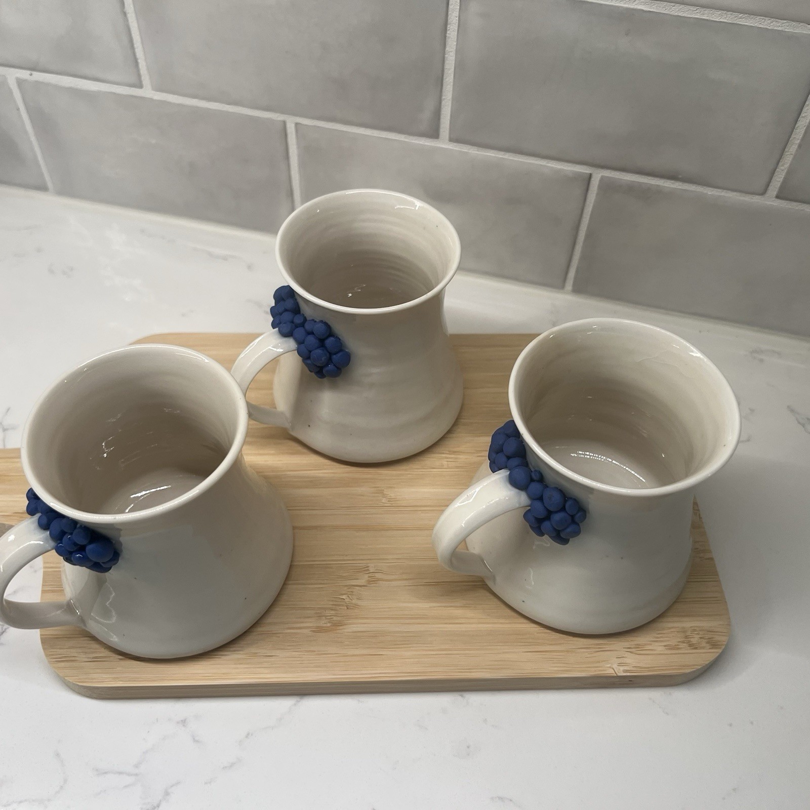 3 Handmade Pottery Mugs with blue grape design around handle, signed by artist