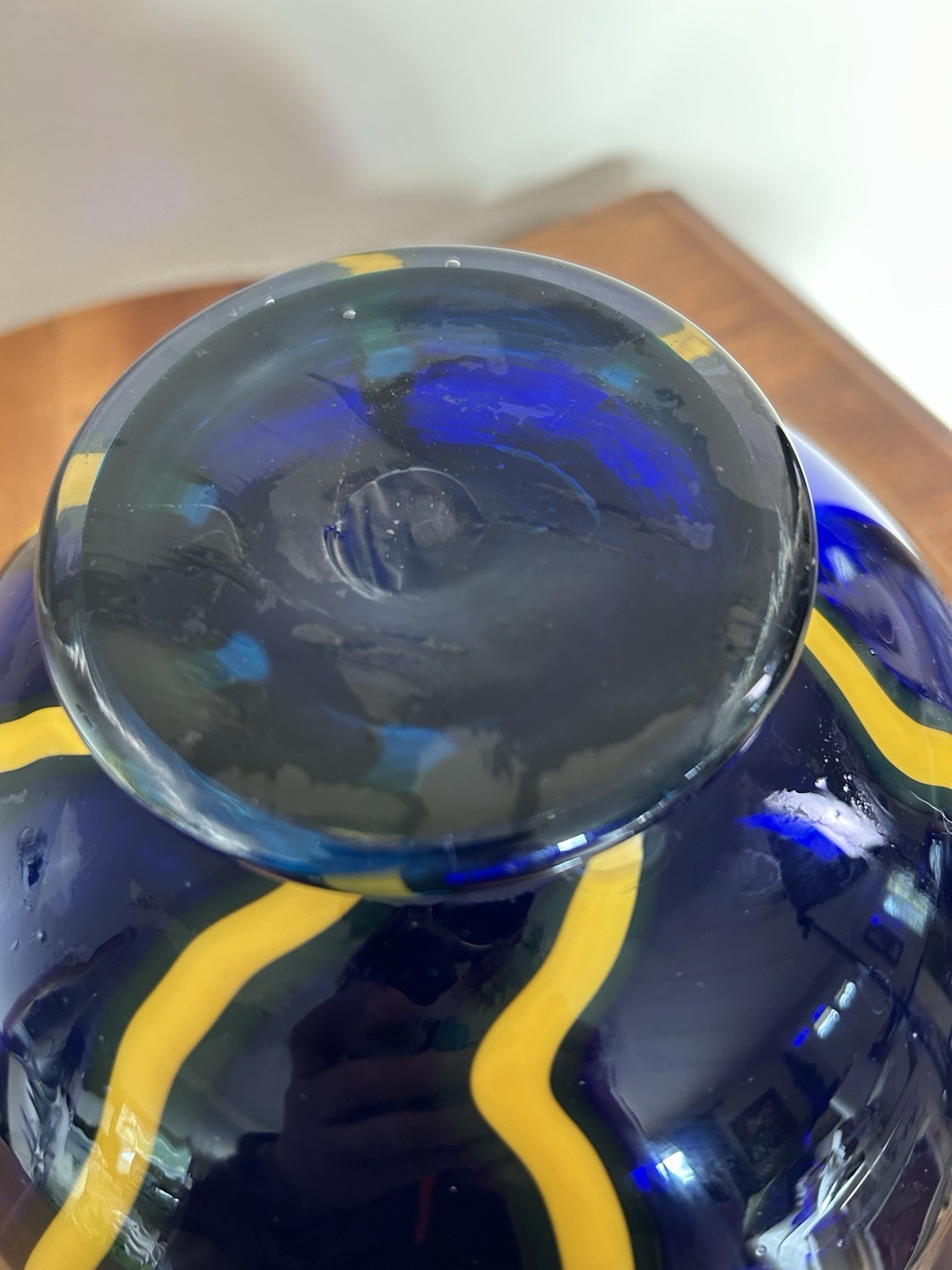 Cobalt blue art glass bowl with yellow and white design