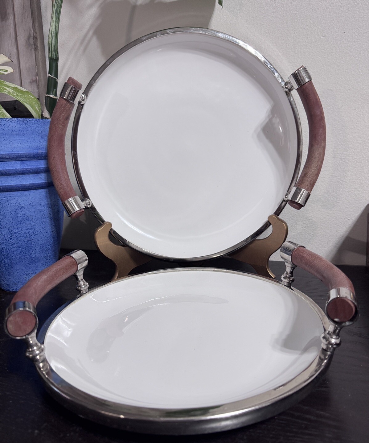 Set Of Two White Ceramic Salad Trys With Wooden Handles And Chrome Rims.