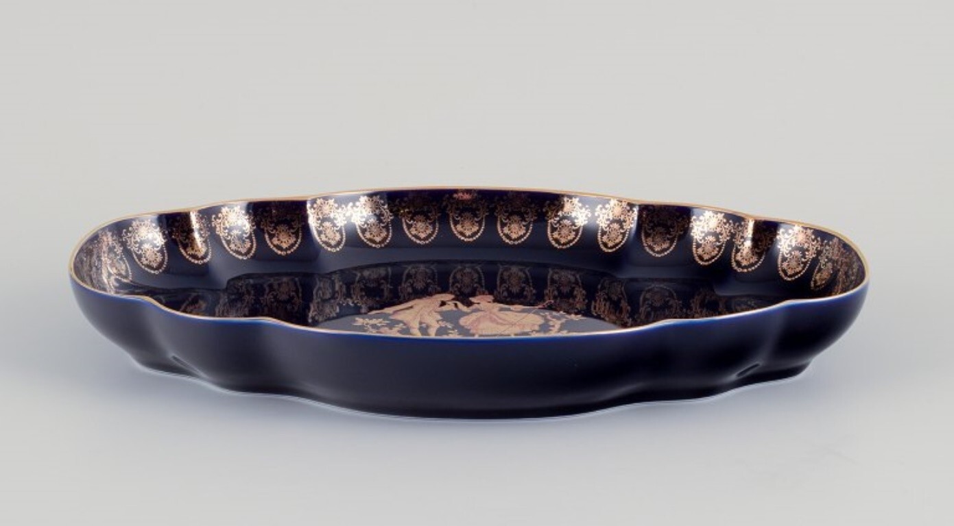 Limoges, France. Two porcelain serving platters adorned with 22-karat gold leaf