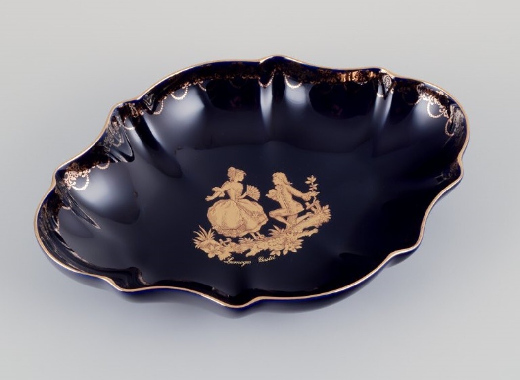 Limoges, France. Two porcelain serving platters adorned with 22-karat gold leaf