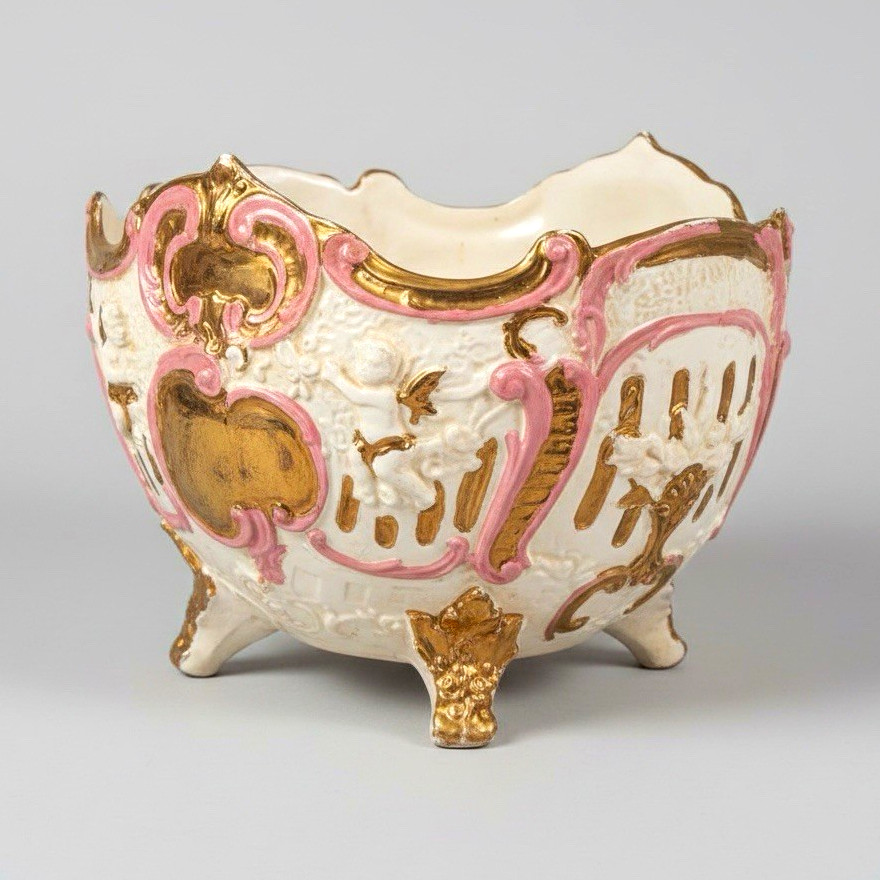 Ornate, footed bowl with applied decoration, characteristic of Capodimonte