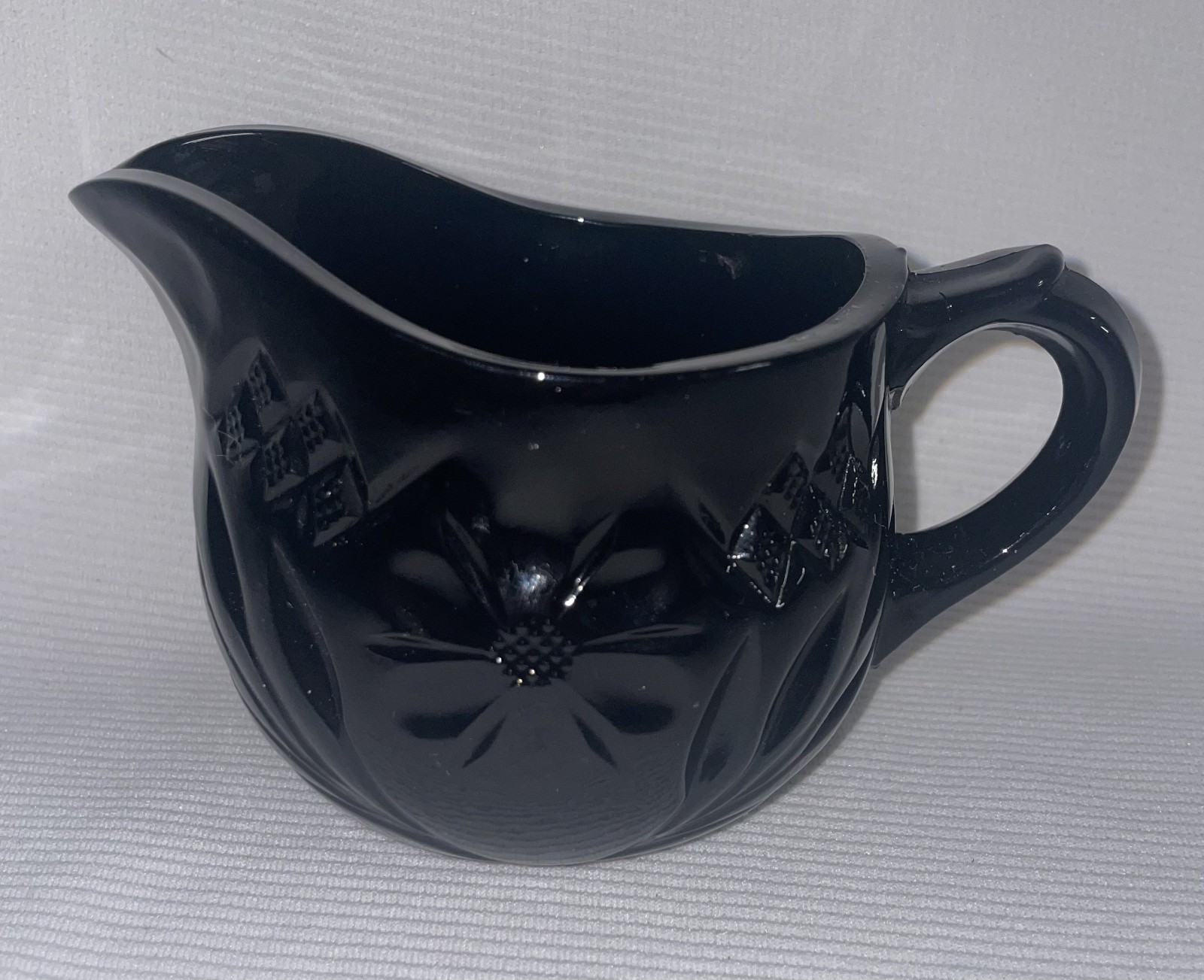 Black Glass Creamer “Monarch Paneled Daisy Pattern” 3 inches High