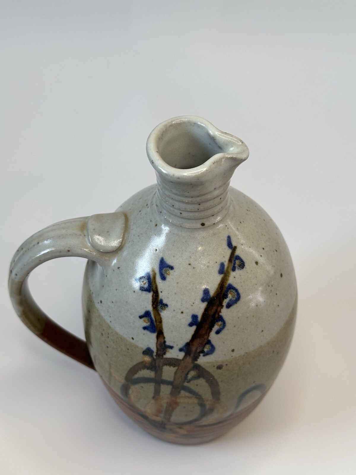 Signed AM stoneware jug, gray, tan, rust, blue, brown. Earthy Natural colors.