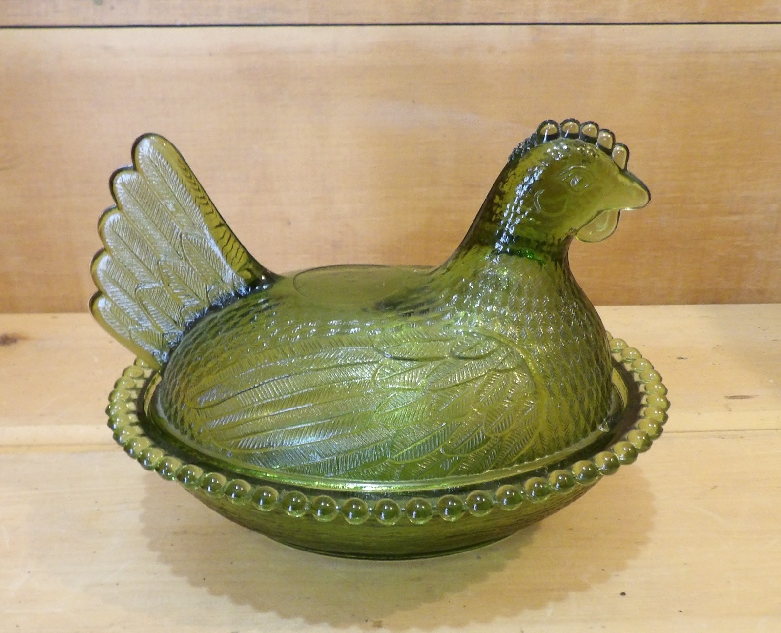 1 Indiana Glass Olive Green Hen on a Nest. 7″L x 5½”W x 5¼”H. There is one Chip