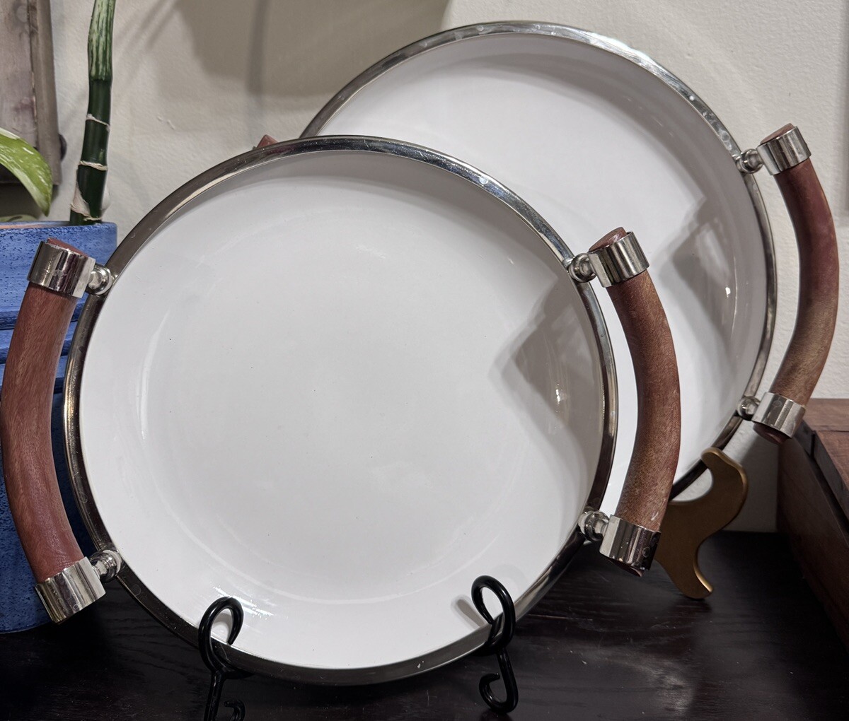 Set Of Two White Ceramic Salad Trys With Wooden Handles And Chrome Rims.