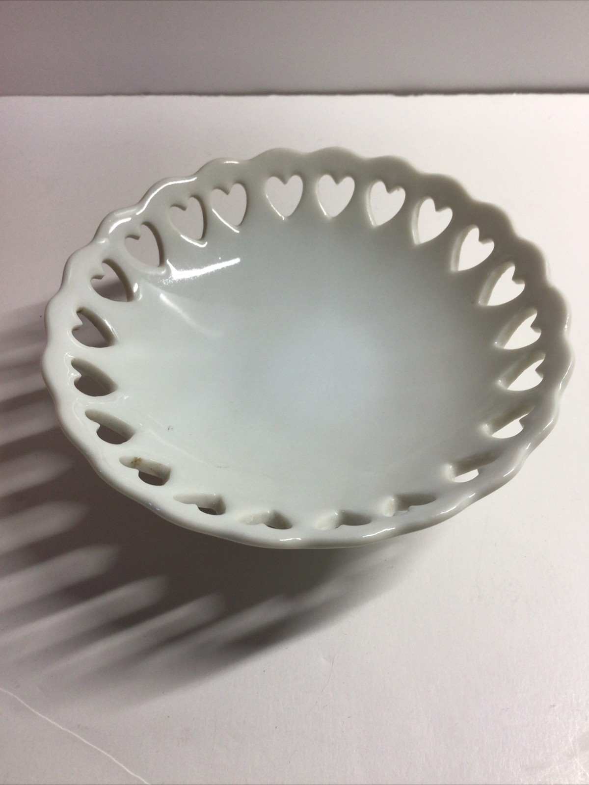 Small White Pedestal Bowl Featuring Cut Out Hearts Around the Top Edge and Base
