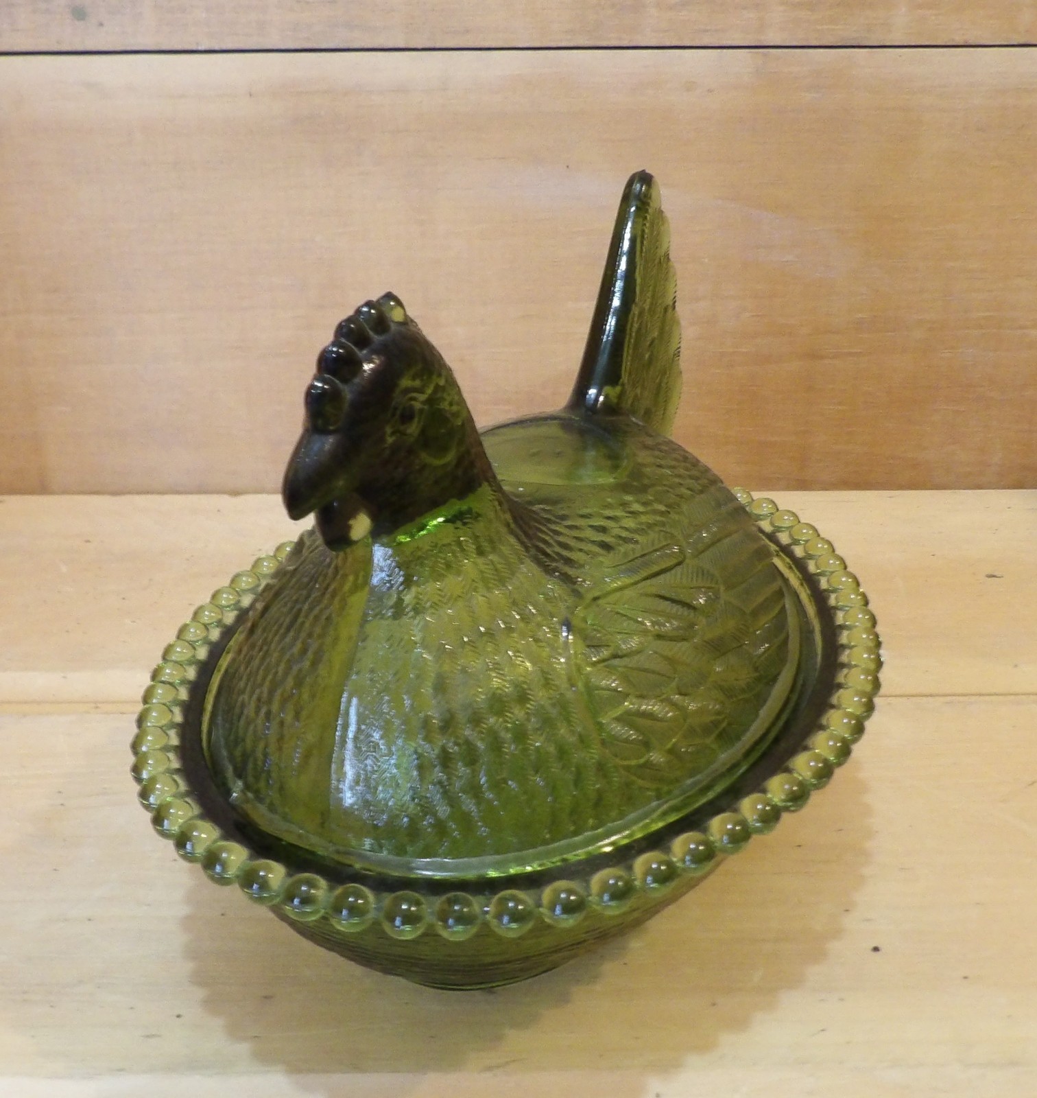 1 Indiana Glass Olive Green Hen on a Nest. 7″L x 5½”W x 5¼”H. There is one Chip