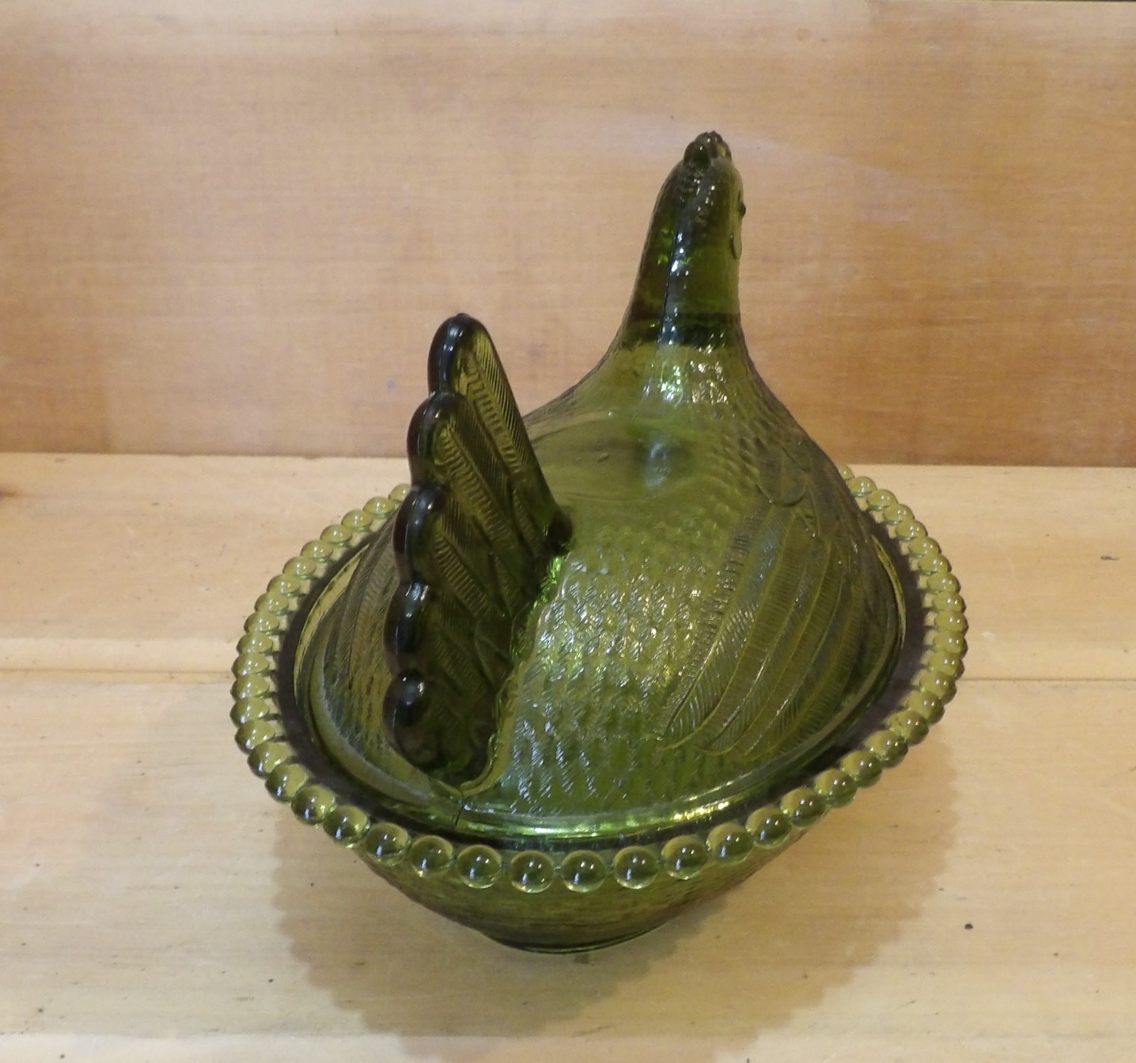 1 Indiana Glass Olive Green Hen on a Nest. 7″L x 5½”W x 5¼”H. There is one Chip