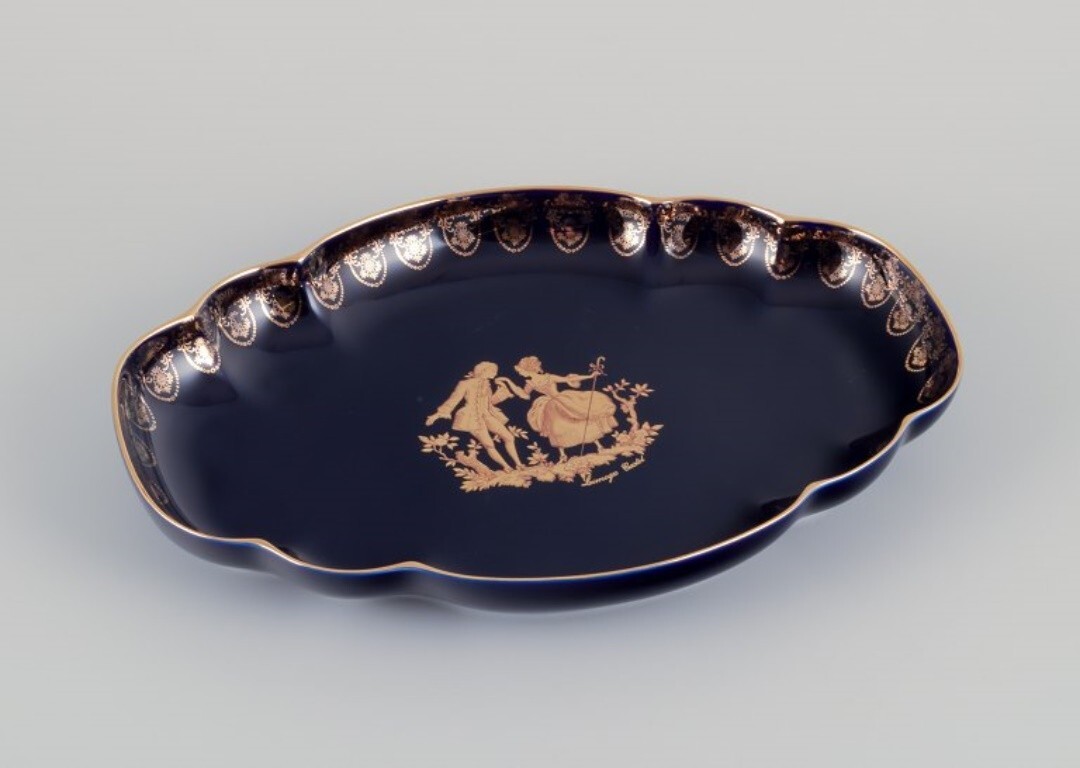 Limoges, France. Two porcelain serving platters adorned with 22-karat gold leaf