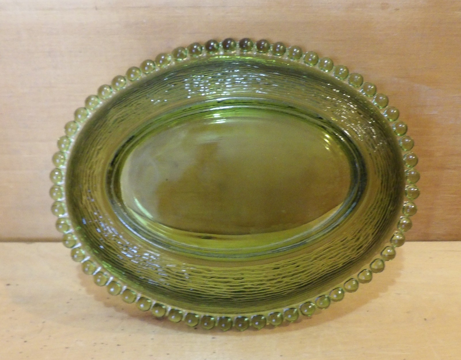 1 Indiana Glass Olive Green Hen on a Nest. 7″L x 5½”W x 5¼”H. There is one Chip