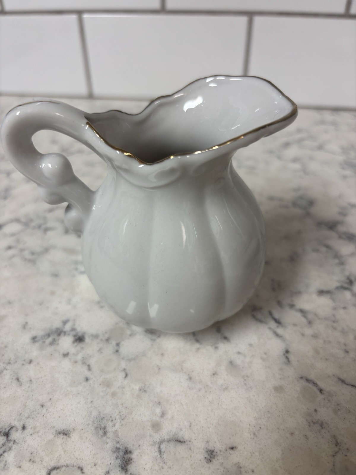 VTG porcelain creamer and saucer set with floral and butterfly. Made In Japan.