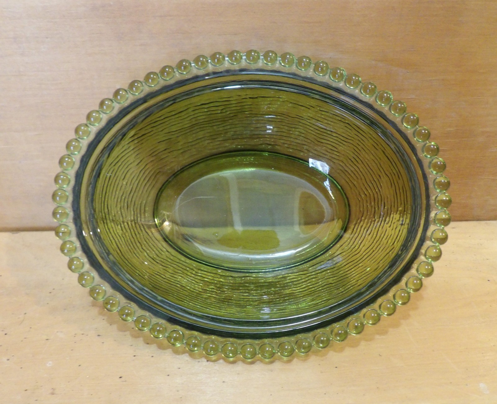 1 Indiana Glass Olive Green Hen on a Nest. 7″L x 5½”W x 5¼”H. There is one Chip