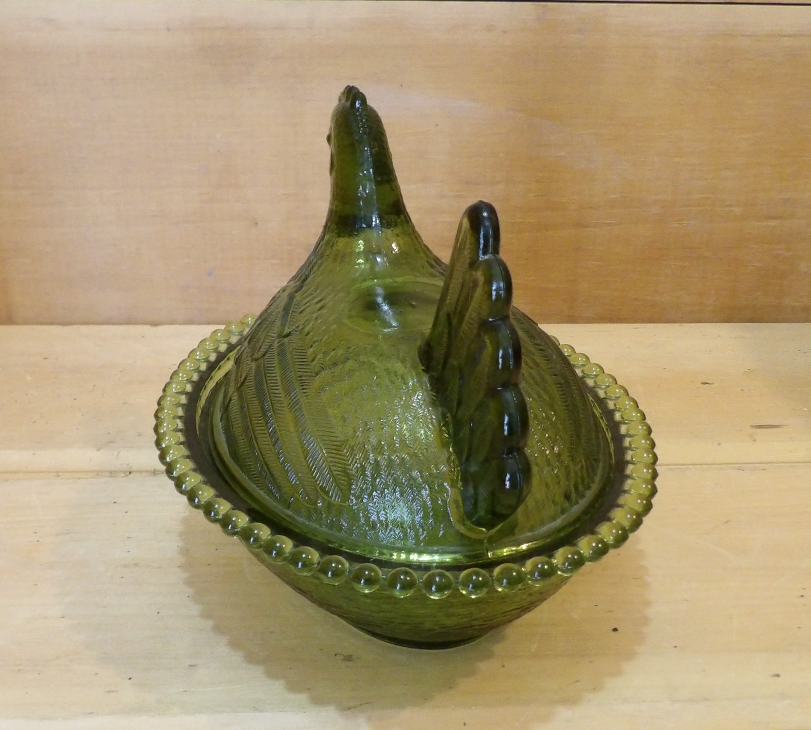 1 Indiana Glass Olive Green Hen on a Nest. 7″L x 5½”W x 5¼”H. There is one Chip