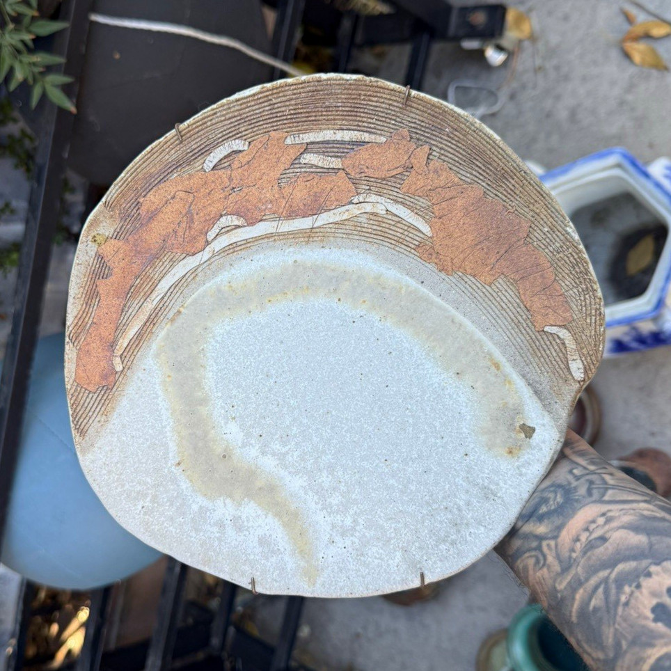 handcrafted studio art pottery plate, likely featuring a textured, unglazed exte
