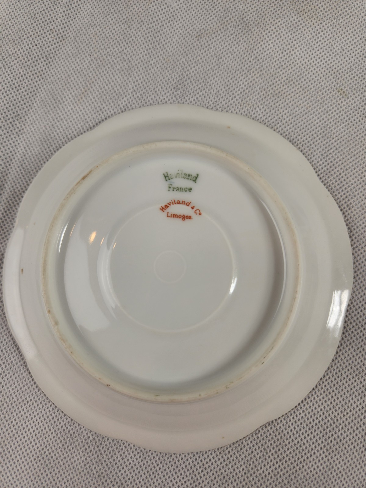 This is a Vintage Haviland Limoges saucer in a pink and green floral pattern.