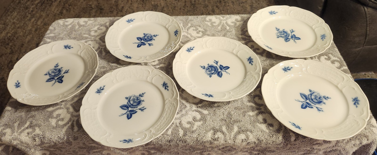 A set of 6 Rosenthal Sanssouci Blue Rose porcelain plates with embossed rims.