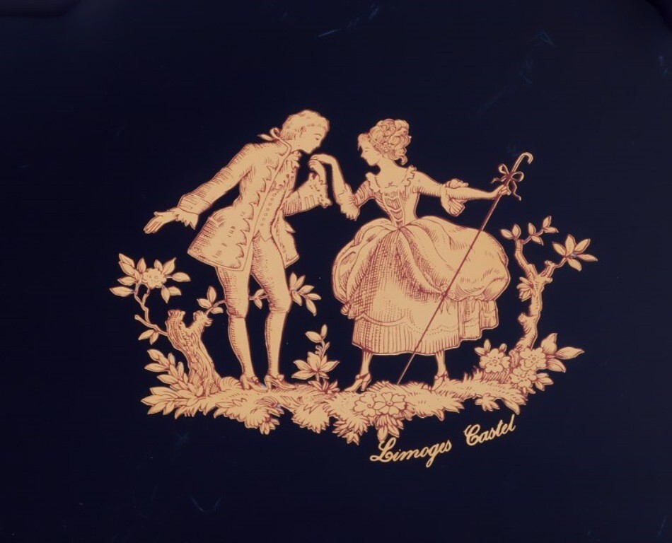 Limoges, France. Two porcelain serving platters adorned with 22-karat gold leaf