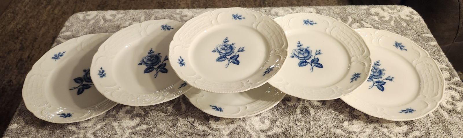 A set of 6 Rosenthal Sanssouci Blue Rose porcelain plates with embossed rims.