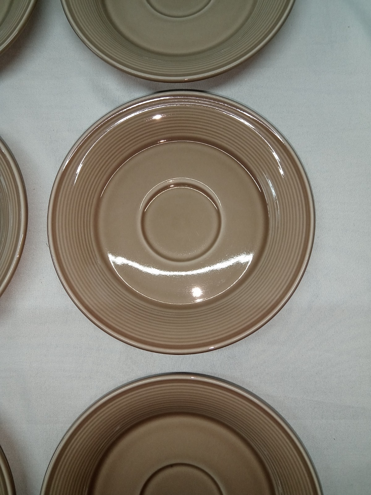 1 – Nancy Calhoun Light Brown Saucer 6 1/4″ diam. (N1)