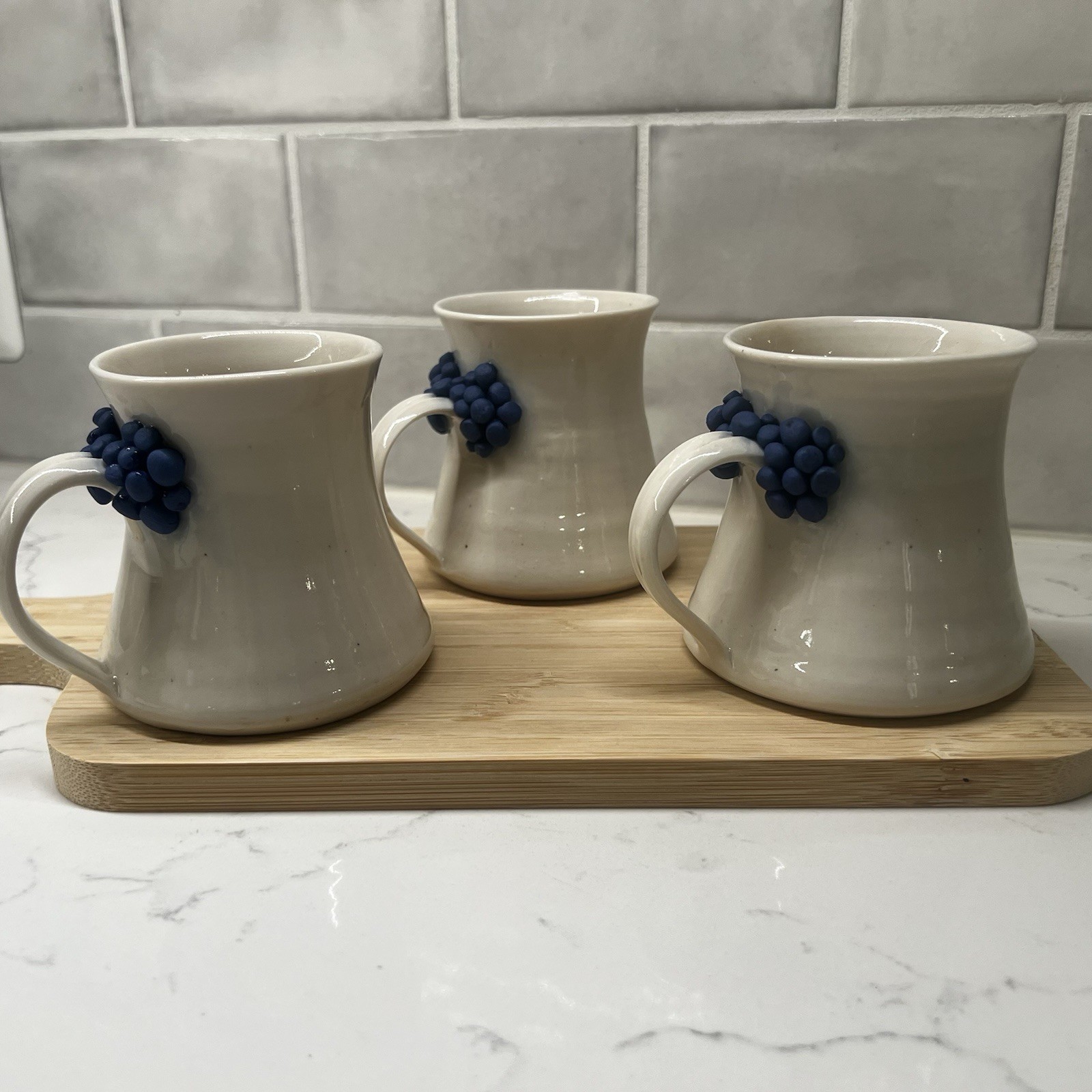 3 Handmade Pottery Mugs with blue grape design around handle, signed by artist