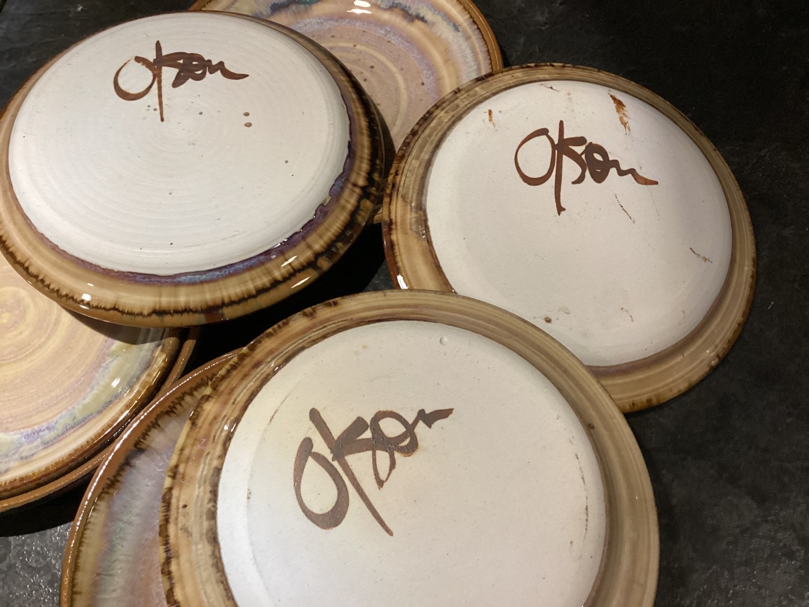 Vintage Greg Olson Handmade NINE Plates 7 1/2in Brown Rim Multicolor pre-owned