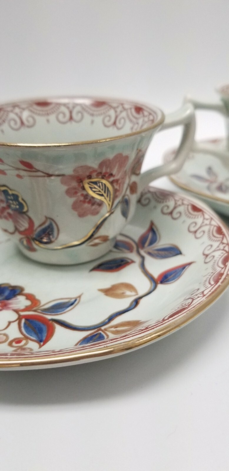 Calyx Ware hand painted 2 teacup saucer set gold light green rust blue England
