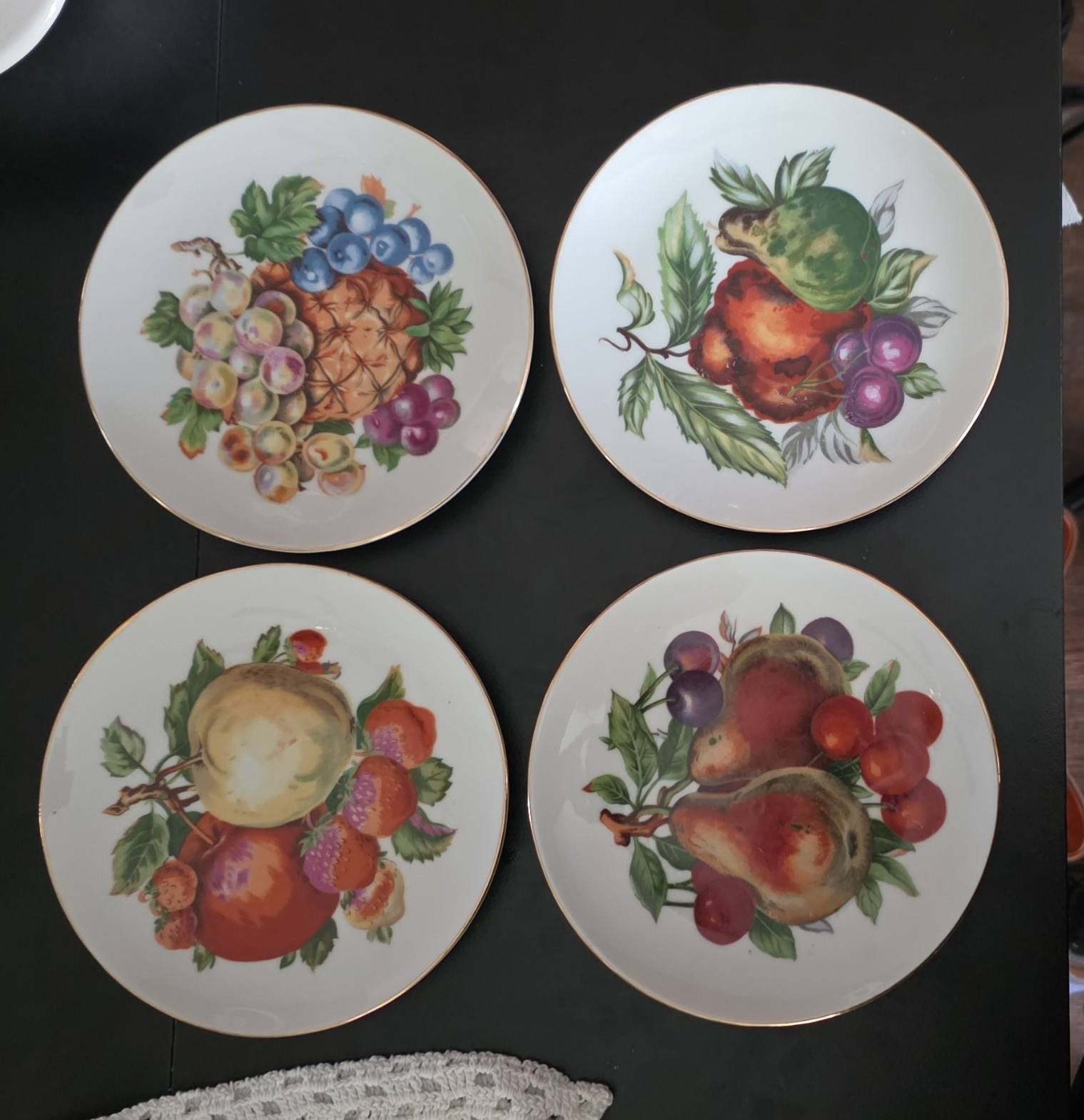 Vintage set of 4 fruit themed plates with wall hangers, gold rim, no call outs.