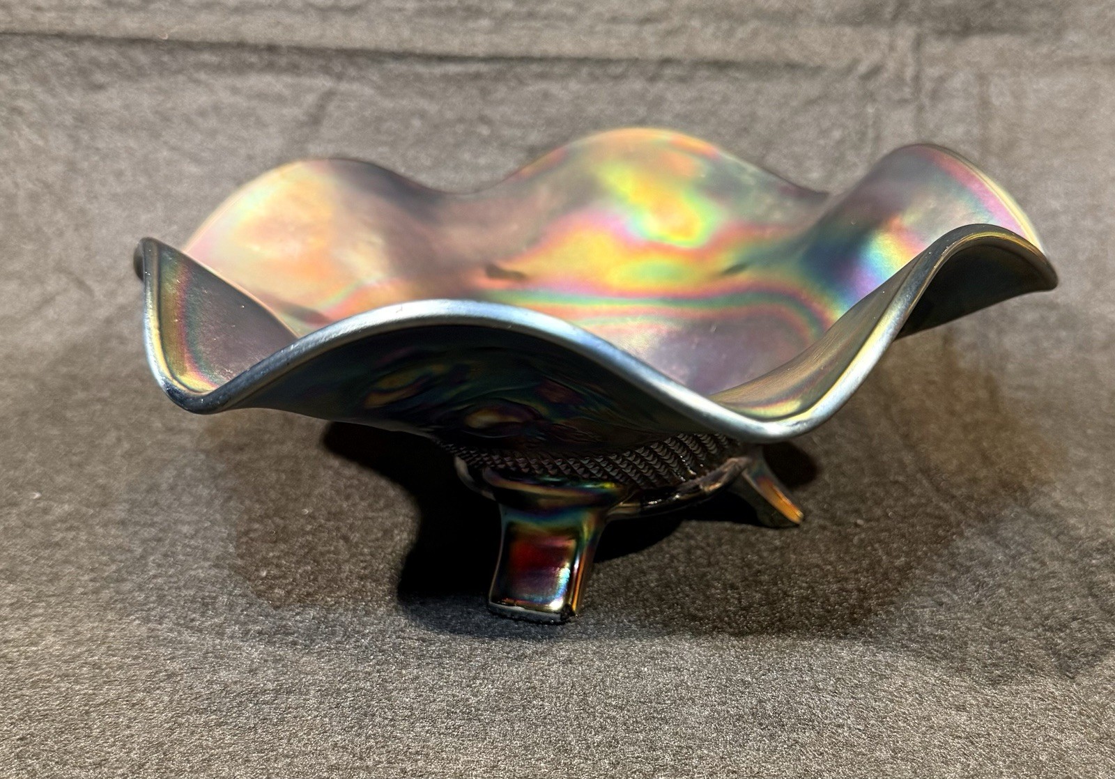 Carnival glass ruffled bowl with three-toed base, likely by Northwood