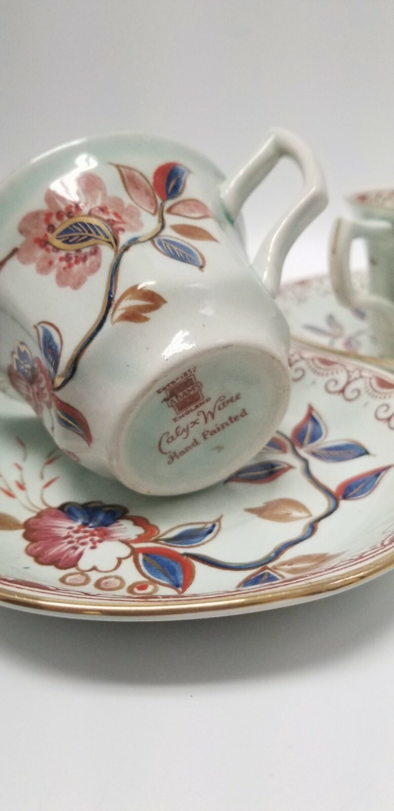Calyx Ware hand painted 2 teacup saucer set gold light green rust blue England